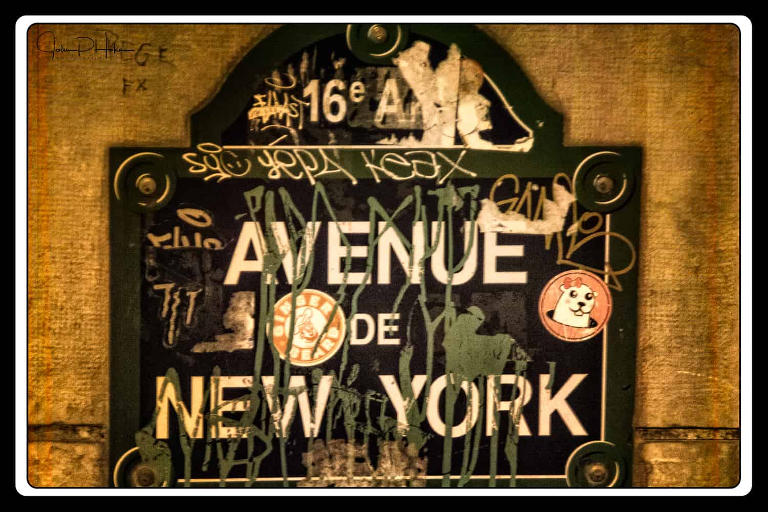 Graffiti on a street sign for the Avenue de New York, Paris, France