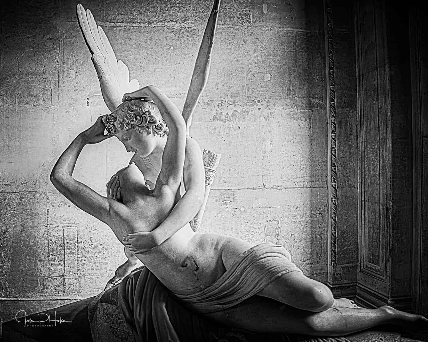 Marble statue in Black and White of Cupid and Psyche embracing from the Louvre Museum, Paris France