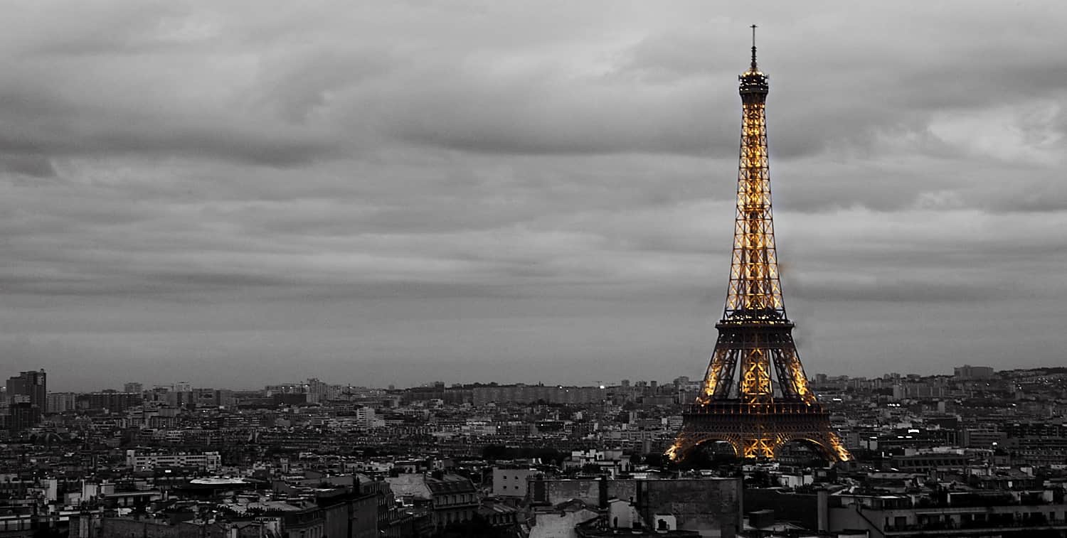 Paris Skyline and the Eiffel Tower - Black and white image of the Paris skyline with the Eiffel Tower lit up in color