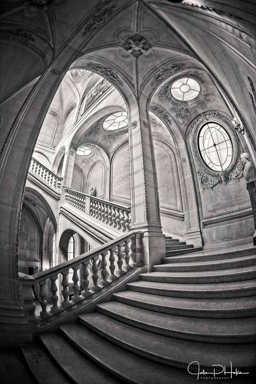 Black and white HDR image of a staircase at the Louvre Museum in the style of Escher
