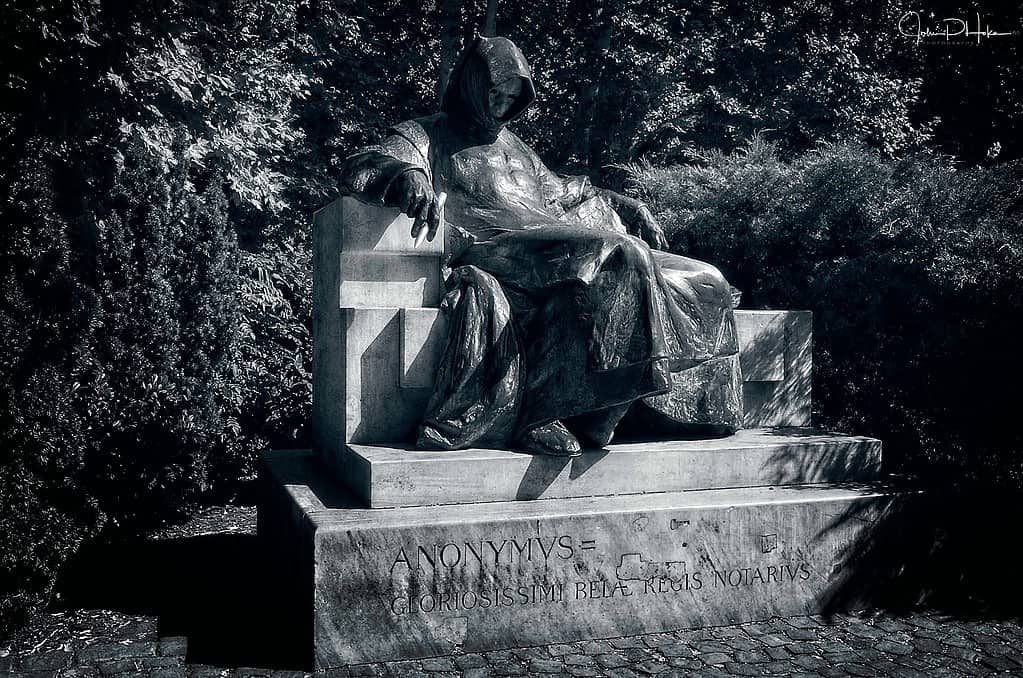 black and white image of the statue of the hooded figure opposite Vajdahunyad Castle is that of Anonymous, the unknown chronicler at the court of King Béla III, who wrote a history of the early Magyars.