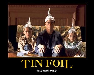 A family sitting on a couch with tinfoil hats on