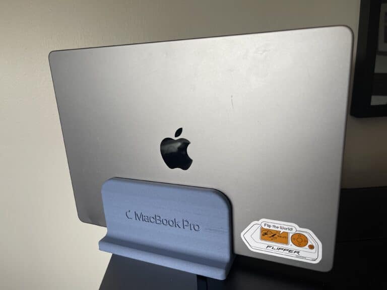 MacBook Pro Stand 3d printed to hold the device vertically between two monitors